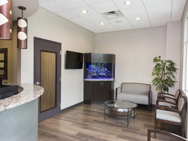 The waiting room at Tindal Prosthodontics, with seating and an aquarium.
