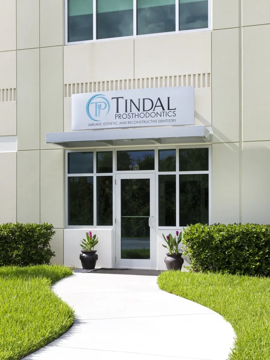 The entrance to Tindal Prosthodontics, with the practice sign above the door.
